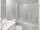 Spotless bathroom with all white tile, vanity and large shower/tub at 8891 Commons Townes Dr, Raleigh, NC 27616