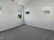 Bright bedroom featuring neutral walls, plush carpeting and large windows for ample natural light at 8891 Commons Townes Dr, Raleigh, NC 27616