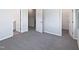 Neutral bedroom with multiple doors and a walk in closet at 8891 Commons Townes Dr, Raleigh, NC 27616