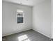 Cozy bedroom with neutral walls and large window offers natural light and pleasant neighborhood views at 8891 Commons Townes Dr, Raleigh, NC 27616