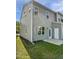 Rear exterior view of well-maintained home with lawn, patio, back door and ample natural light at 8891 Commons Townes Dr, Raleigh, NC 27616