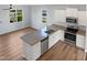 Modern kitchen features stainless steel appliances, granite counters and hardwood flooring at 8891 Commons Townes Dr, Raleigh, NC 27616