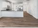 Open-concept kitchen boasts white cabinets, stainless steel appliances, and a spacious island at 8891 Commons Townes Dr, Raleigh, NC 27616