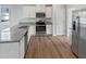 Stylish kitchen boasting white cabinets, stainless appliances, and granite countertops at 8891 Commons Townes Dr, Raleigh, NC 27616