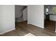 Inviting living room with hardwood flooring, staircase access, seamlessly connecting kitchen areas at 8891 Commons Townes Dr, Raleigh, NC 27616