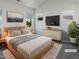 Calm main bedroom with light wood accents, a soft color palette, and minimalist design at 8891 Commons Townes Dr, Raleigh, NC 27616