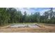 Foundation under construction showing concrete slab and rebar on a wooded lot at 90 Caspian Ct, Lillington, NC 27546