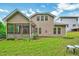 Expansive backyard view of home exterior, with screened porch and ample green space at 921 Shefford Town Dr, Rolesville, NC 27571