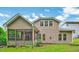 Backyard view featuring siding, windows, a screened porch, and green grass under a blue sky at 921 Shefford Town Dr, Rolesville, NC 27571
