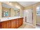 Bathroom featuring a double sink vanity with wood cabinets and a glass-enclosed shower at 921 Shefford Town Dr, Rolesville, NC 27571