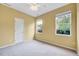 Bedroom featuring neutral carpet, paint, trim, and two windows offering natural light at 921 Shefford Town Dr, Rolesville, NC 27571