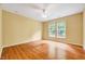 Bright bedroom with wood floors, a ceiling fan, and two windows at 921 Shefford Town Dr, Rolesville, NC 27571