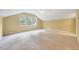 Spacious bonus room with natural light, neutral carpet, and a vaulted ceiling at 921 Shefford Town Dr, Rolesville, NC 27571