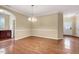 Dining area with hardwood floors and elegant lighting, open to the entryway at 921 Shefford Town Dr, Rolesville, NC 27571