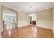 Dining room with hardwood floors and elegant lighting, open to living room and kitchen at 921 Shefford Town Dr, Rolesville, NC 27571