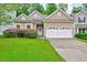 Charming home featuring a well-manicured lawn, tidy shrubbery and a two car garage at 921 Shefford Town Dr, Rolesville, NC 27571