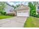 Home exterior showcasing its well-kept lawn, shrubbery, and concrete driveway at 921 Shefford Town Dr, Rolesville, NC 27571
