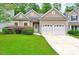 Charming single-story home featuring a well-manicured lawn and a two-car garage at 921 Shefford Town Dr, Rolesville, NC 27571