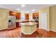 Modern kitchen with stainless steel appliances, island, and hardwood floors at 921 Shefford Town Dr, Rolesville, NC 27571