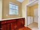Convenient laundry room with tile flooring, storage cabinets and natural light at 921 Shefford Town Dr, Rolesville, NC 27571