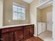 Functional laundry room with granite countertops, storage cabinets, and modern appliances at 921 Shefford Town Dr, Rolesville, NC 27571
