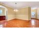 Spacious living room area featuring hardwood floors, archways, and great lighting at 921 Shefford Town Dr, Rolesville, NC 27571