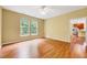 Bright living room featuring hardwood floors, neutral paint, and abundant natural light from two large windows at 921 Shefford Town Dr, Rolesville, NC 27571