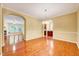 Open-concept living area with hardwood floors, archways, and abundant natural light at 921 Shefford Town Dr, Rolesville, NC 27571