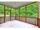 Inviting screened porch with wood frame and view of lush greenery, perfect for enjoying the outdoors at 921 Shefford Town Dr, Rolesville, NC 27571