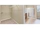 Walk-in closet showing wire shelving adjacent to full bathroom at 921 Shefford Town Dr, Rolesville, NC 27571