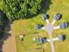 Aerial view of a neighborhood featuring well-maintained lawns and a cul-de-sac surrounded by lush trees at 97 Arapahoe Dr, Kenly, NC 27542