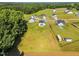 An aerial view of a neighborhood with well-spaced homes, lush greenery, and ample open space at 97 Arapahoe Dr, Kenly, NC 27542