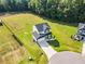 Aerial view of the property featuring a spacious yard and proximity to wooded areas at 97 Arapahoe Dr, Kenly, NC 27542