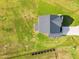 An aerial view of a modern house with a gray roof and a long driveway surrounded by green lawn at 97 Arapahoe Dr, Kenly, NC 27542