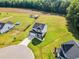 A home with a two-car garage and a driveway surrounded by well-maintained lawns and greenery at 97 Arapahoe Dr, Kenly, NC 27542