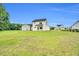 Expansive backyard featuring a modern two-story home with a well-maintained lawn at 97 Arapahoe Dr, Kenly, NC 27542
