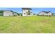 Expansive backyard showcasing a modern two-story home with a well-maintained lawn at 97 Arapahoe Dr, Kenly, NC 27542