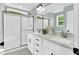 Well-lit bathroom featuring dual sinks, shower and neutral colors at 97 Arapahoe Dr, Kenly, NC 27542