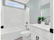 Well-lit bathroom featuring a shower-tub combo and neutral colors at 97 Arapahoe Dr, Kenly, NC 27542