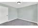A simple bedroom with plush carpet, a door and a light fixture overhead at 97 Arapahoe Dr, Kenly, NC 27542
