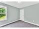 A simple bedroom with plush carpet, a window and a door at 97 Arapahoe Dr, Kenly, NC 27542