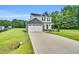 Charming two-story home featuring a two-car garage and landscaped front yard at 97 Arapahoe Dr, Kenly, NC 27542