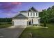 Charming two-story home with a two-car garage and beautifully landscaped front yard at 97 Arapahoe Dr, Kenly, NC 27542