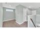 Spacious hallway featuring plush carpet, a window and neutral paint at 97 Arapahoe Dr, Kenly, NC 27542