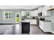 Open kitchen offers white cabinets, stainless steel appliances, granite countertops, and backyard access at 97 Arapahoe Dr, Kenly, NC 27542