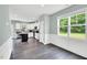 Bright kitchen with white cabinets, stainless appliances, dark island, and a view at 97 Arapahoe Dr, Kenly, NC 27542