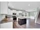 Bright kitchen boasts stainless steel appliances, white cabinets, granite countertops and a central island at 97 Arapahoe Dr, Kenly, NC 27542