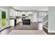 Bright kitchen featuring stainless steel appliances, white cabinets, granite countertops and a central island at 97 Arapahoe Dr, Kenly, NC 27542