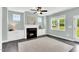 Living room features a fireplace with built-ins, ceiling fan and large windows offering natural light at 97 Arapahoe Dr, Kenly, NC 27542