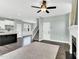 Bright living room featuring dark wood floors, fireplace, ceiling fan, and stairs to the upper level at 97 Arapahoe Dr, Kenly, NC 27542